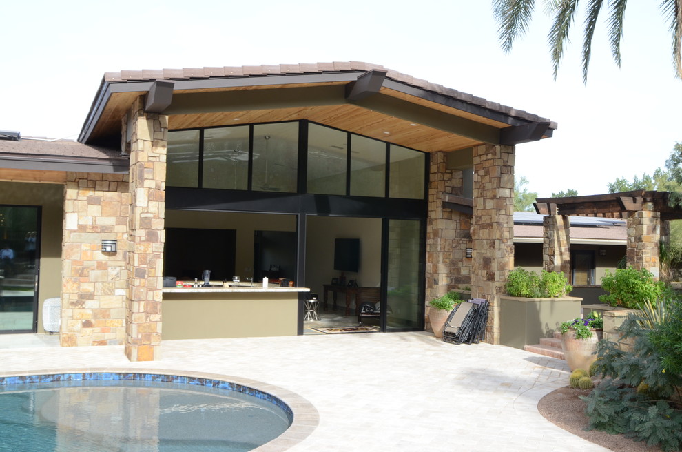 Design ideas for a large midcentury backyard patio in Phoenix with an outdoor kitchen, tile and a roof extension.