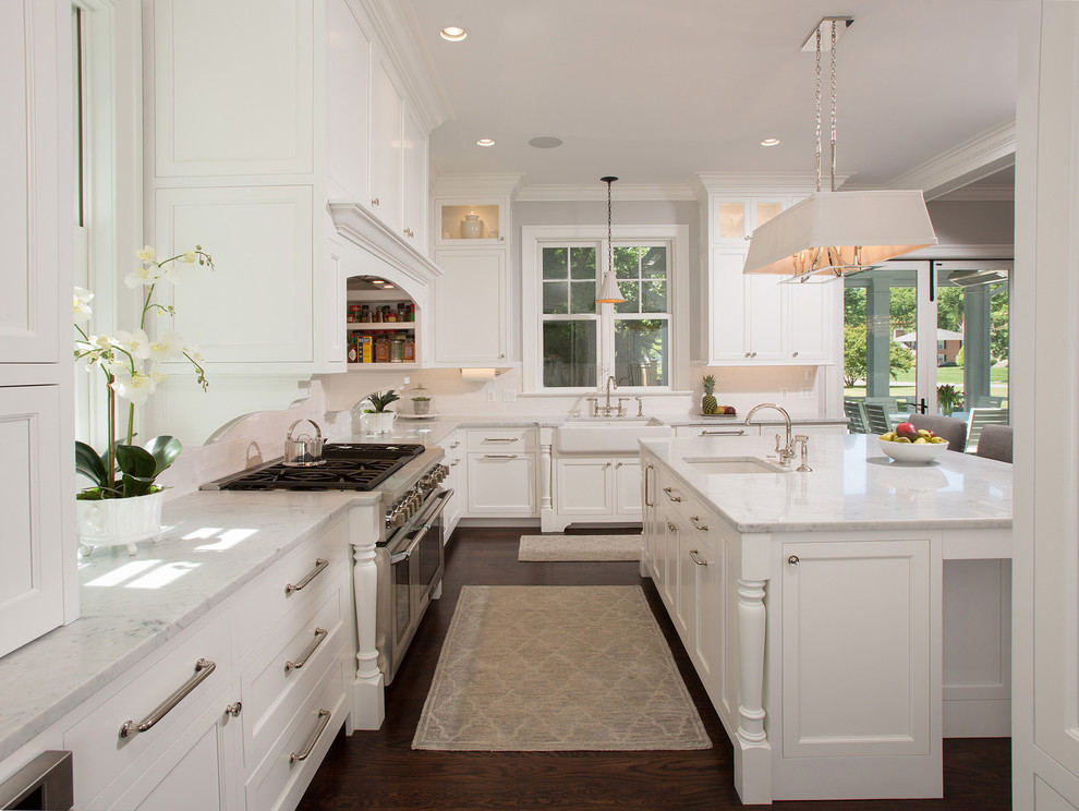 Inspiration for a large country u-shaped eat-in kitchen in DC Metro with recessed-panel cabinets, white cabinets, with island, a farmhouse sink, marble benchtops, white splashback, stainless steel appliances, dark hardwood floors and brown floor.