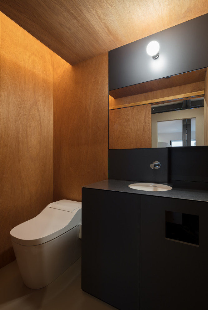 Inspiration for a mid-sized modern linoleum floor, gray floor, wood ceiling and wood wall powder room remodel in Fukuoka with beaded inset cabinets, black cabinets, an undermount sink, stainless steel countertops, black countertops and a built-in vanity