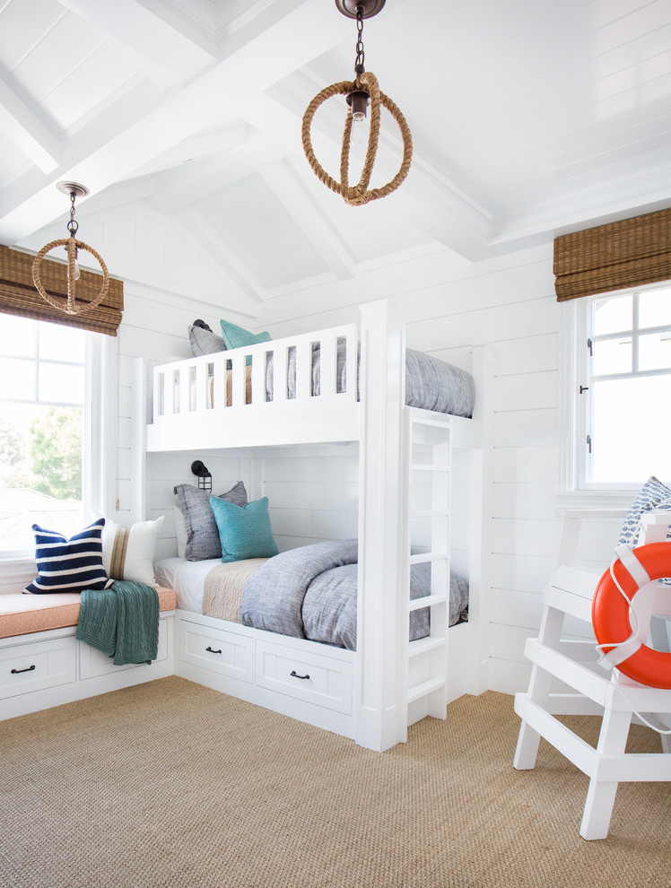 Design ideas for a mid-sized beach style gender-neutral kids' bedroom in Orange County with white walls and carpet.