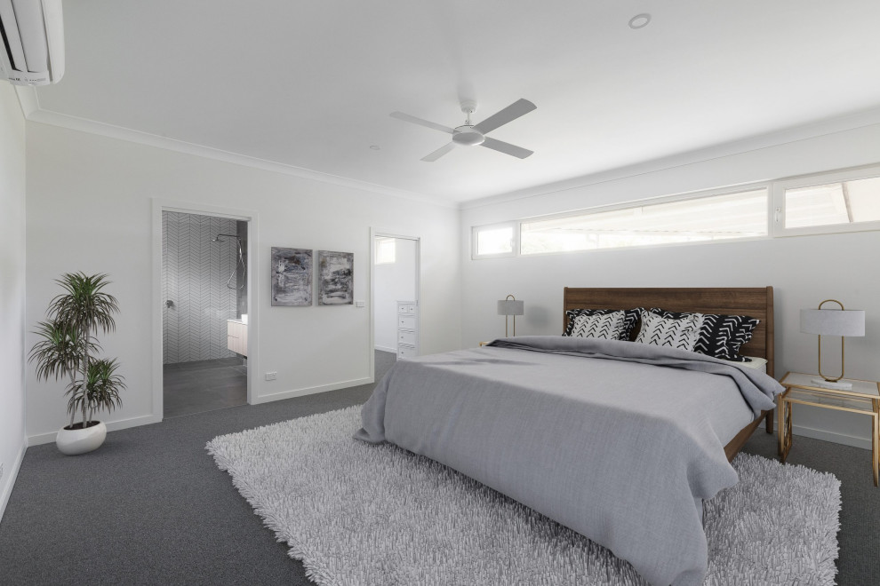 This is an example of a modern bedroom in Melbourne with white walls, carpet and grey floor.