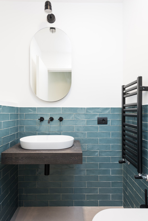 Inspiration for a small contemporary bathroom in Rome with medium wood cabinets, a wall-mount toilet, green tile, porcelain tile, white walls, porcelain floors, a vessel sink, laminate benchtops, beige floor, brown benchtops, a single vanity, a floating vanity and brick walls.