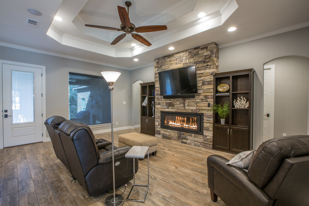 Mid-sized transitional open concept family room in Dallas with grey walls, dark hardwood floors, a ribbon fireplace, a stone fireplace surround and a wall-mounted tv.