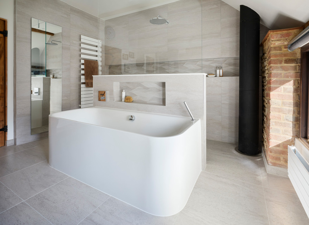 Design ideas for a large modern master bathroom in Oxfordshire with flat-panel cabinets, dark wood cabinets, a freestanding tub, an open shower, a wall-mount toilet, gray tile, porcelain tile, grey walls, porcelain floors, a wall-mount sink, quartzite benchtops, grey floor, an open shower, white benchtops, a floating vanity and exposed beam.