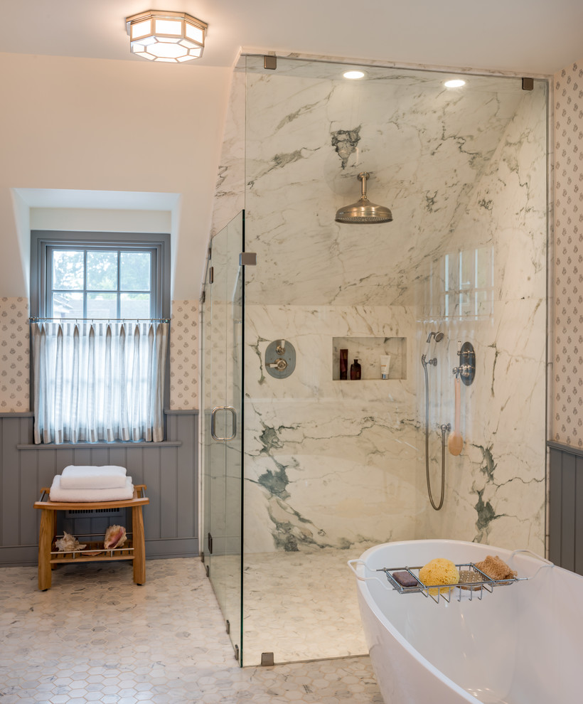 Large traditional master bathroom in Philadelphia with beaded inset cabinets, blue cabinets, a freestanding tub, a corner shower, a one-piece toilet, gray tile, marble, white walls, marble floors, an undermount sink, marble benchtops, grey floor and a hinged shower door.