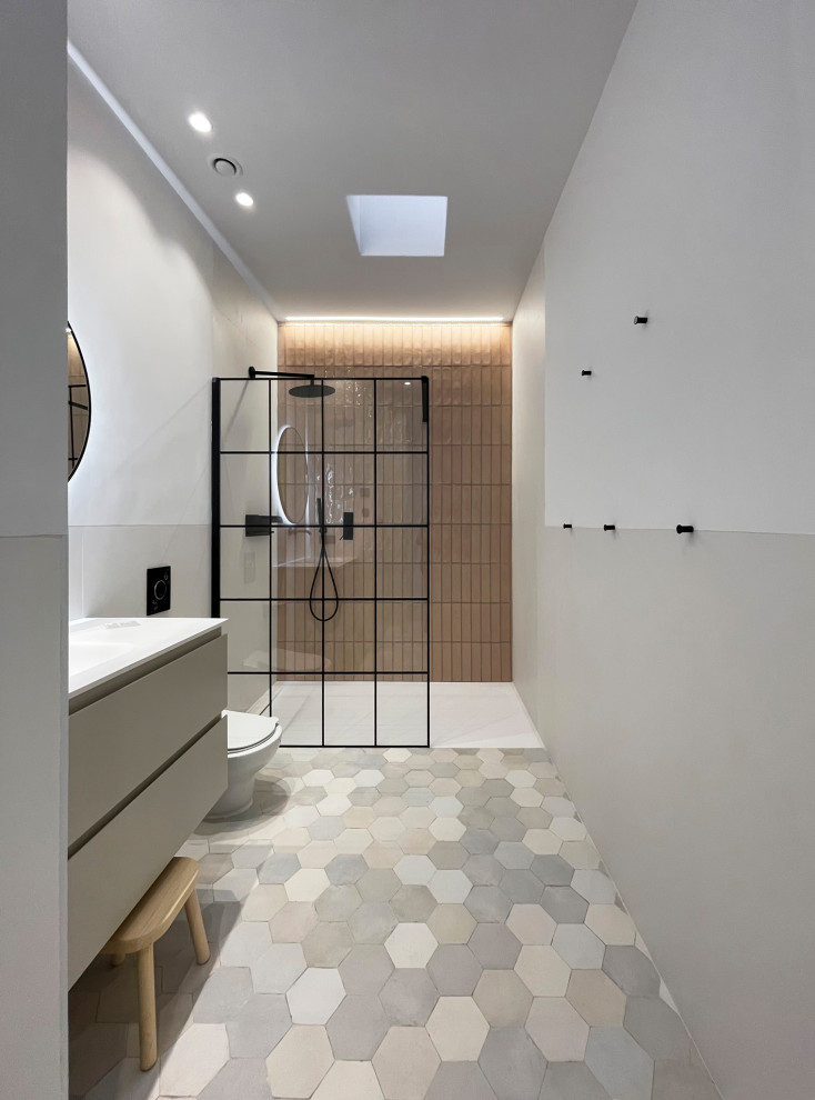 Inspiration for a mid-sized mediterranean kids bathroom in Other with flat-panel cabinets, beige cabinets, a curbless shower, a one-piece toilet, pink tile, ceramic tile, white walls, ceramic floors, an integrated sink, engineered quartz benchtops, red floor, white benchtops, a single vanity and a built-in vanity.