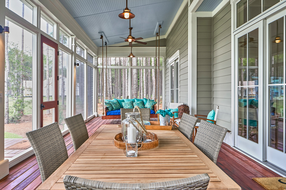 Inspiration for a large traditional backyard screened-in verandah in Charleston with decking and a roof extension.