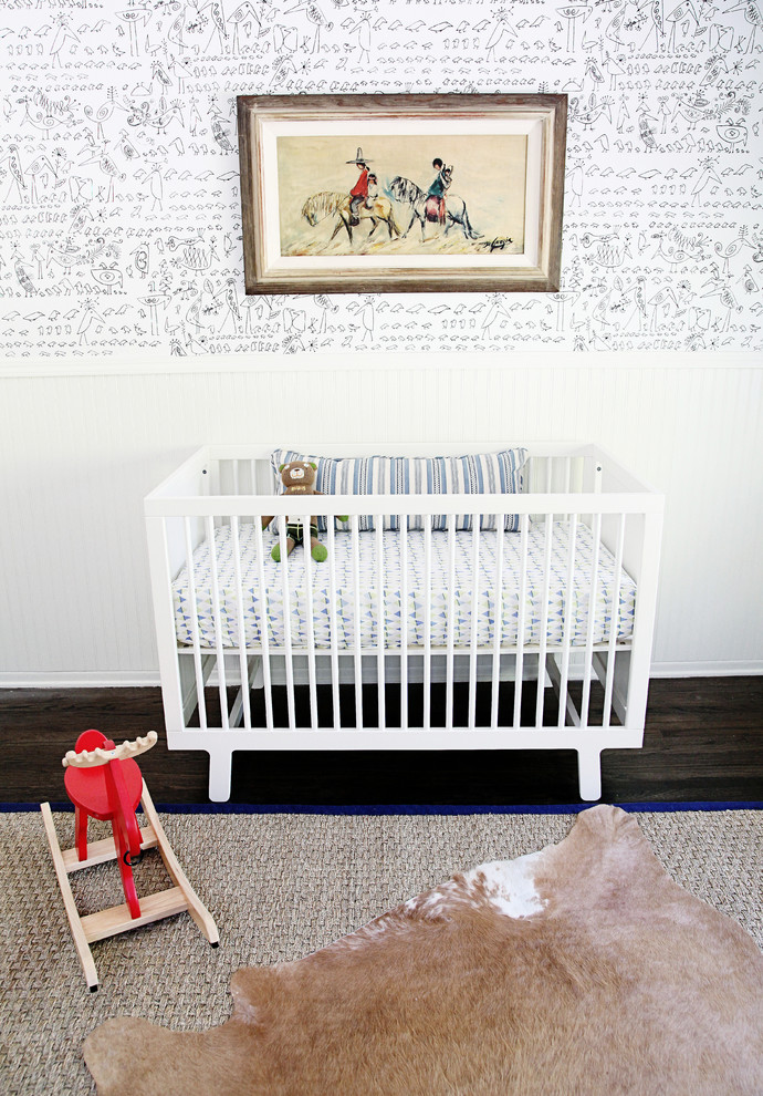 Design ideas for a mid-sized modern nursery for boys in Los Angeles with multi-coloured walls and dark hardwood floors.
