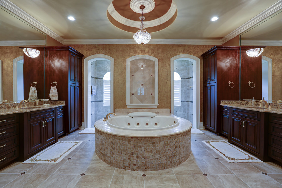 Design ideas for a large traditional master bathroom in Jacksonville with raised-panel cabinets, dark wood cabinets, a hot tub, an alcove shower, beige tile, beige walls, ceramic floors, an undermount sink and granite benchtops.