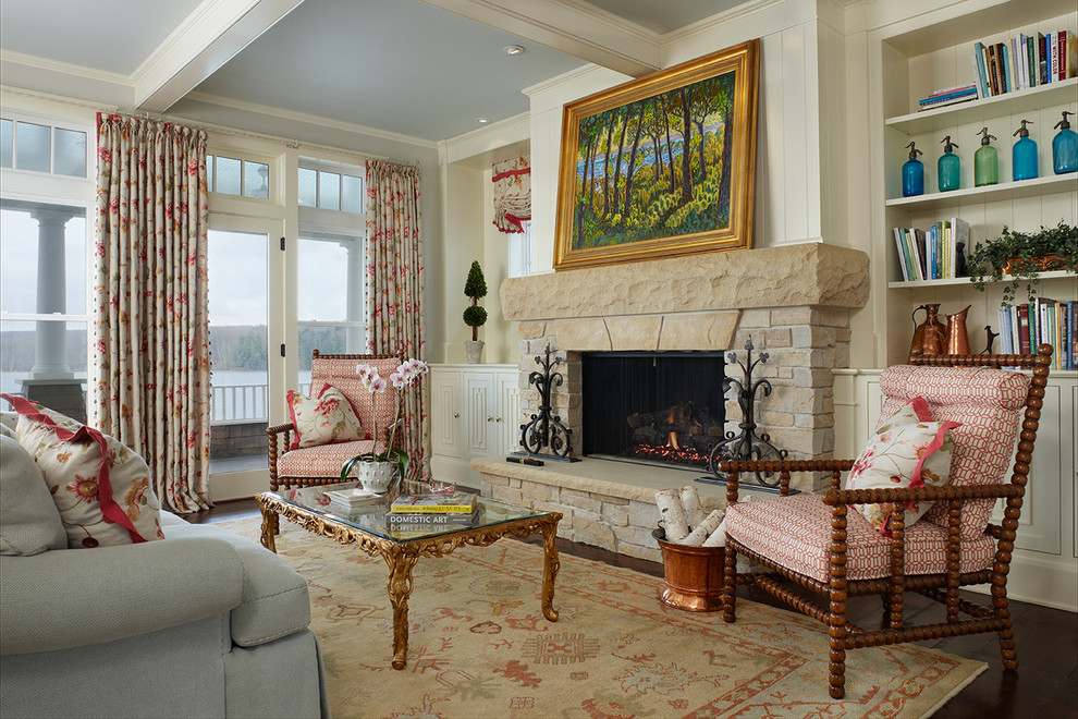 This is an example of a traditional living room in Detroit with a stone fireplace surround and dark hardwood floors.