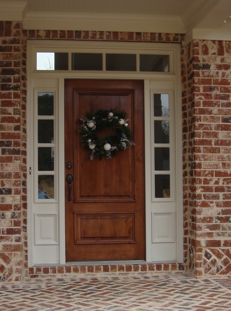 This is an example of a mid-sized traditional brick brown house exterior in Atlanta.