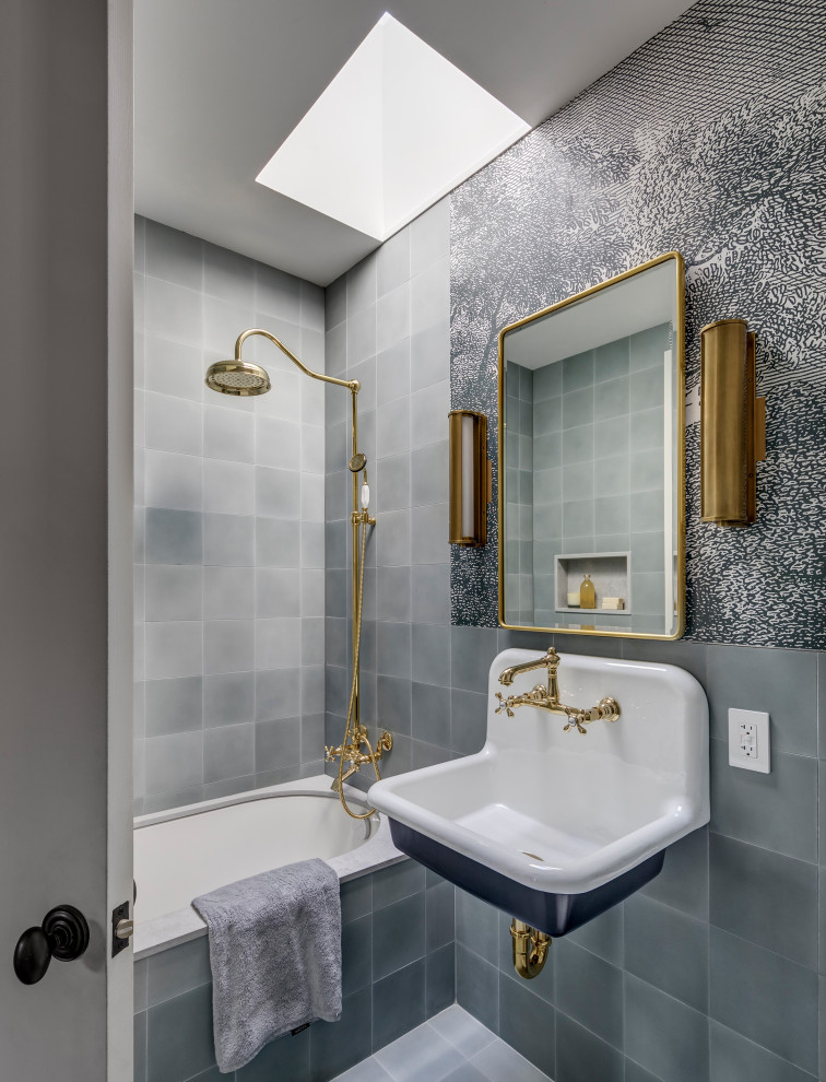 This is an example of a transitional bathroom in New York with an alcove tub, a shower/bathtub combo, cement tiles, an undermount sink, a single vanity, multi-coloured walls, an open shower and wallpaper.