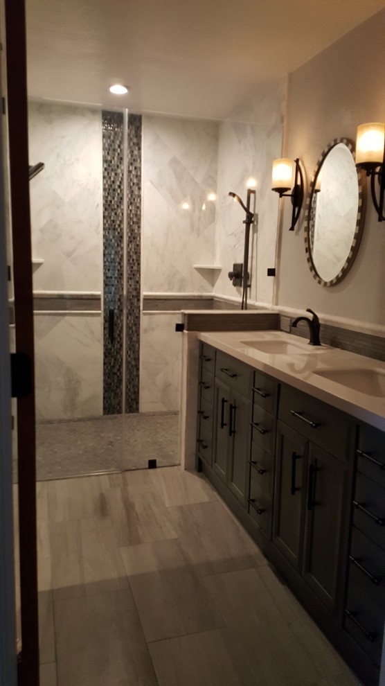 Inspiration for a mid-sized modern master bathroom in San Francisco with recessed-panel cabinets, grey cabinets, a freestanding tub, a corner shower, white tile, metal tile, beige walls, porcelain floors, an undermount sink, engineered quartz benchtops, beige floor, a hinged shower door and beige benchtops.