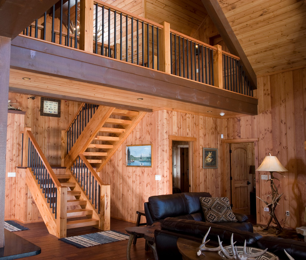 Photo of a large country wood l-shaped staircase in Other with wood risers.