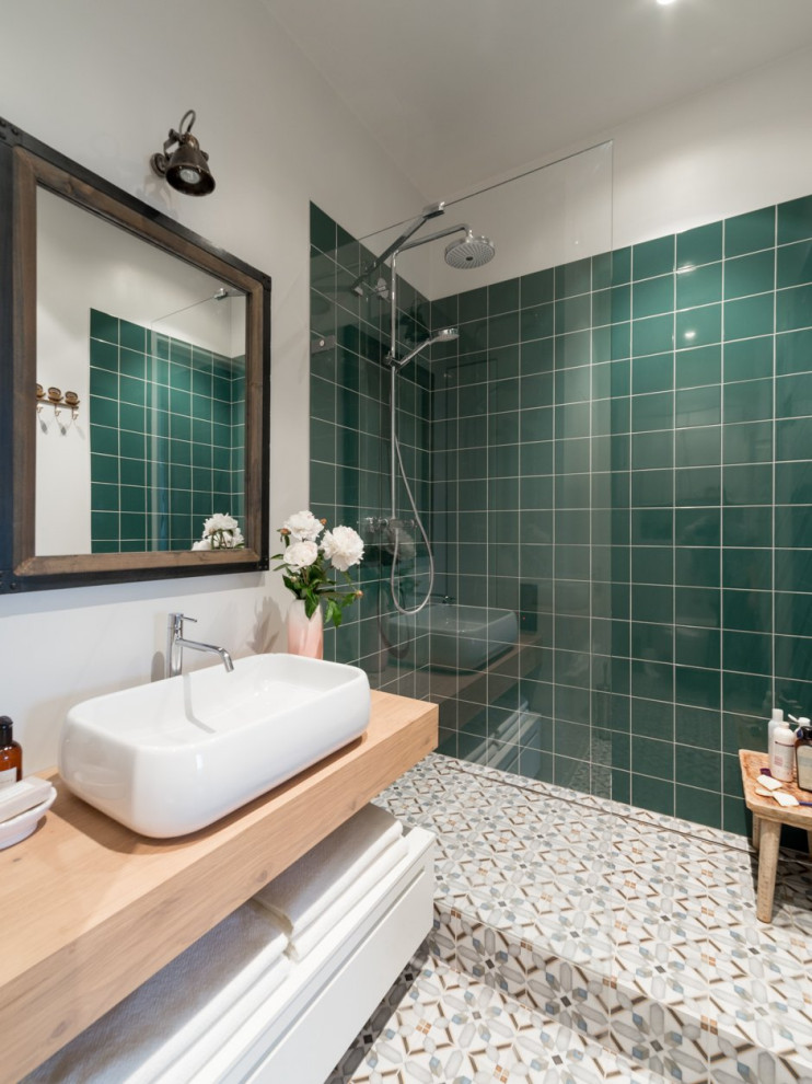 Mid-sized asian master wet room bathroom in San Francisco with beige cabinets, green tile, white walls, cement tiles, a vessel sink, wood benchtops, multi-coloured floor, an open shower, beige benchtops, a shower seat, a single vanity and a floating vanity.