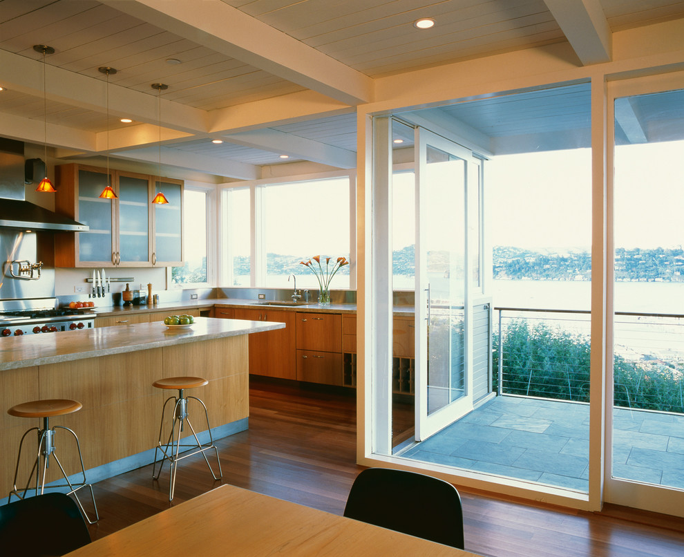 Photo of a contemporary eat-in kitchen in San Francisco with flat-panel cabinets and medium wood cabinets.