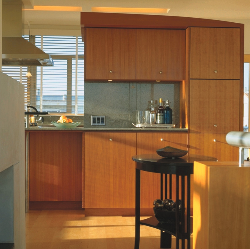 Inspiration for a large contemporary galley light wood floor eat-in kitchen remodel in Los Angeles with flat-panel cabinets, medium tone wood cabinets, granite countertops, stainless steel appliances and an island