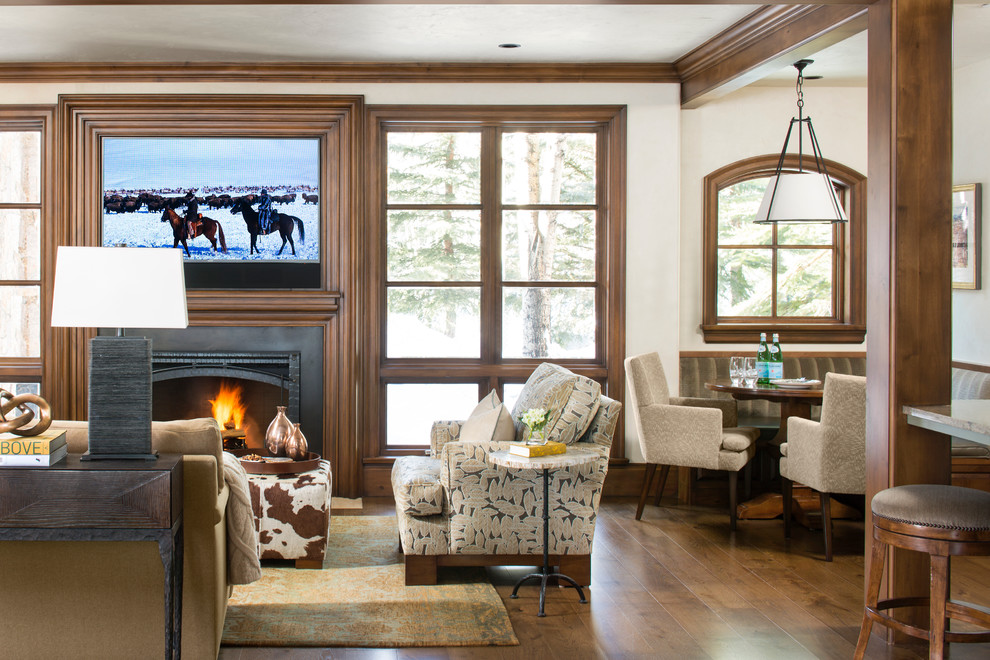 Design ideas for a large country open concept living room in Denver with white walls, a standard fireplace, a stone fireplace surround, a concealed tv and medium hardwood floors.