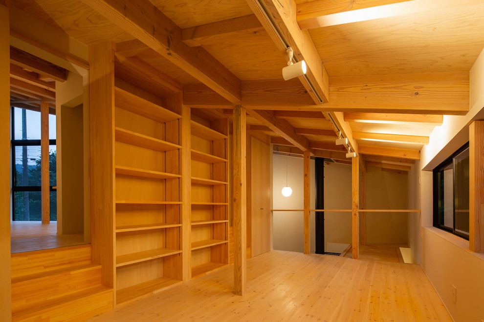 This is an example of a small asian gender-neutral kids' playroom in Nagoya with white walls, light hardwood floors, beige floor and exposed beam.
