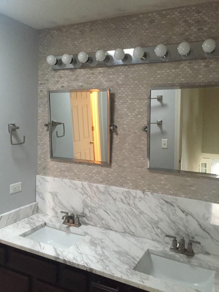 Large transitional master beige tile and porcelain tile bathroom photo in Chicago with raised-panel cabinets, dark wood cabinets, gray walls, an undermount sink and marble countertops