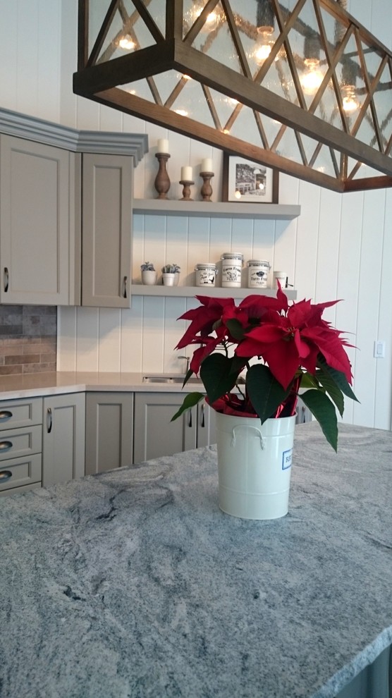 Example of a mid-sized transitional single-wall ceramic tile kitchen design in Toronto with an undermount sink, gray cabinets, stainless steel appliances, an island, recessed-panel cabinets, quartz countertops, gray backsplash and stone tile backsplash