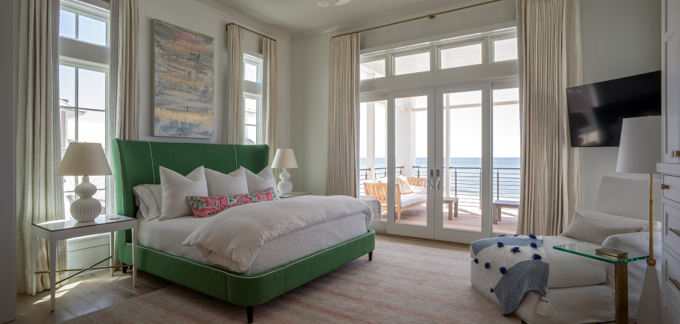 Example of a large beach style guest light wood floor and beige floor bedroom design in Other with white walls