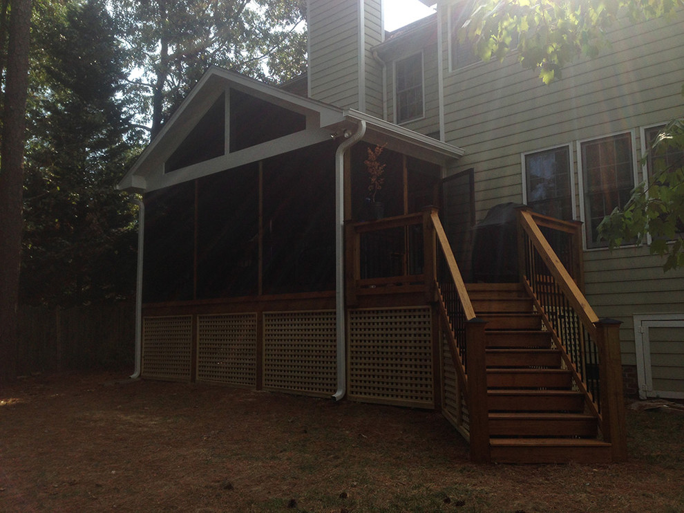 Small transitional side yard deck photo in Raleigh with a roof extension