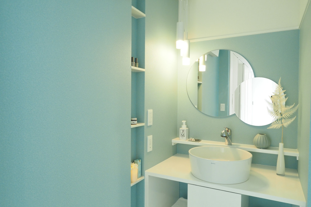 Photo of a contemporary cloakroom in Other with blue walls, white floors, a feature wall and a wallpapered ceiling.