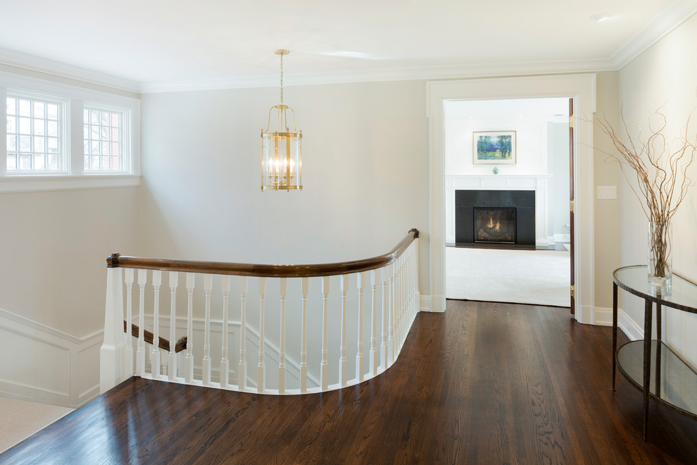 This is an example of a mid-sized traditional hallway in Minneapolis with beige walls and dark hardwood floors.