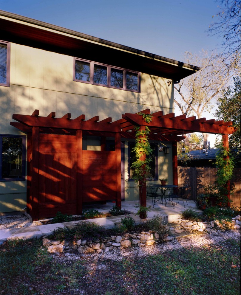 Inspiration for a mid-sized contemporary two-storey stucco beige duplex exterior in Austin with a flat roof.