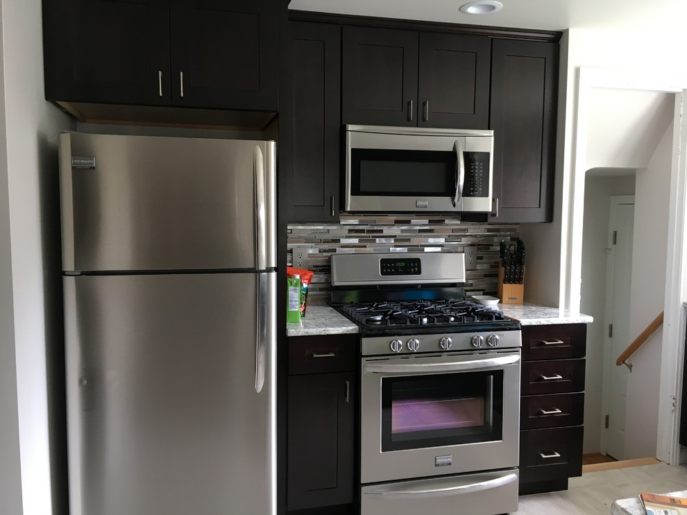 Example of a small transitional u-shaped porcelain tile and white floor kitchen design in Cincinnati with shaker cabinets, quartzite countertops, stainless steel appliances and a peninsula