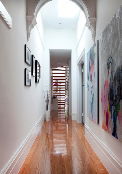 Design ideas for a small traditional hallway in Melbourne with white walls and medium hardwood floors.