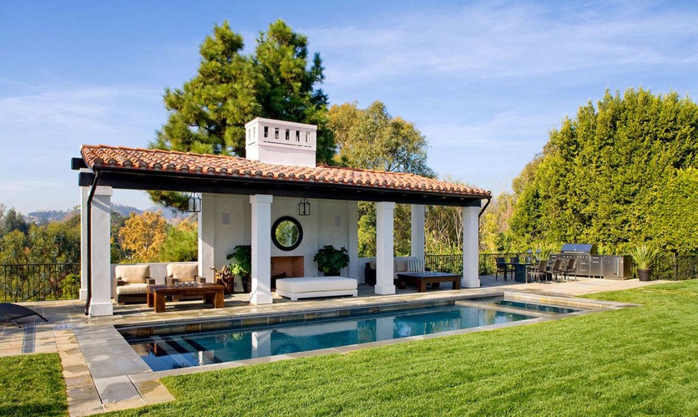 Mediterranean backyard rectangular lap pool in Los Angeles with a hot tub.