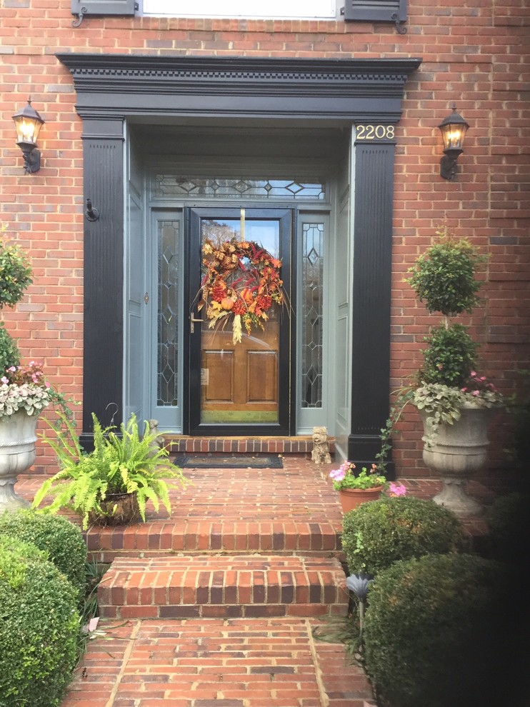 Design ideas for a mid-sized traditional front door in Louisville with a single front door and a medium wood front door.