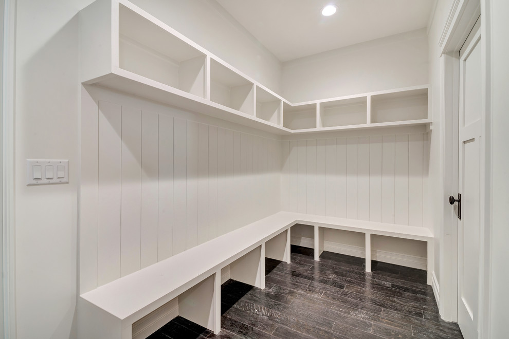Photo of a mid-sized transitional mudroom in Salt Lake City with white walls, dark hardwood floors, a single front door, a white front door and brown floor.