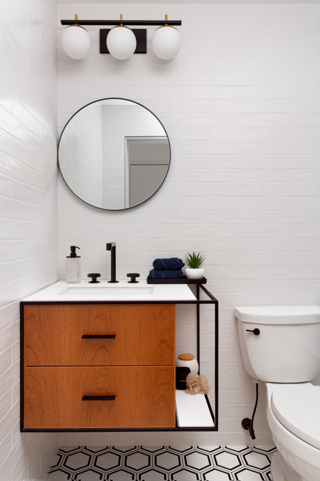 Design ideas for a small contemporary kids bathroom in New York with flat-panel cabinets, medium wood cabinets, an alcove tub, a one-piece toilet, blue tile, porcelain tile, white walls, porcelain floors, white floor, a niche, a single vanity and a floating vanity.