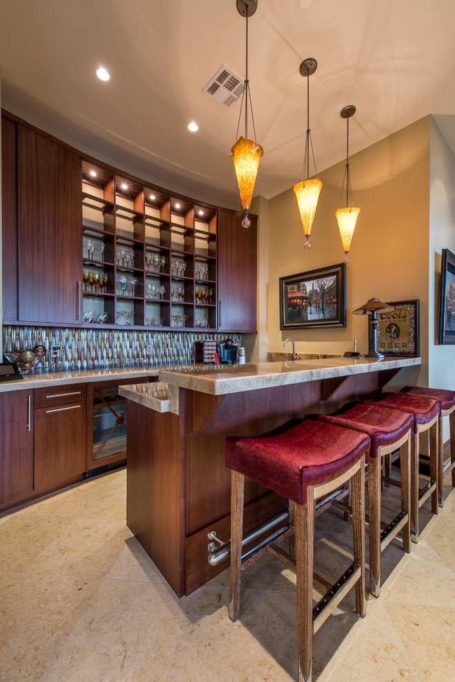 This is an example of a contemporary home bar in Las Vegas with flat-panel cabinets, dark wood cabinets and mosaic tile splashback.