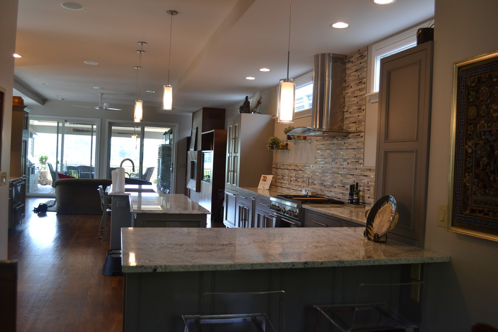 Example of a large transitional l-shaped medium tone wood floor open concept kitchen design in Cincinnati with an undermount sink, gray cabinets, granite countertops, multicolored backsplash, mosaic tile backsplash, stainless steel appliances, an island and beaded inset cabinets