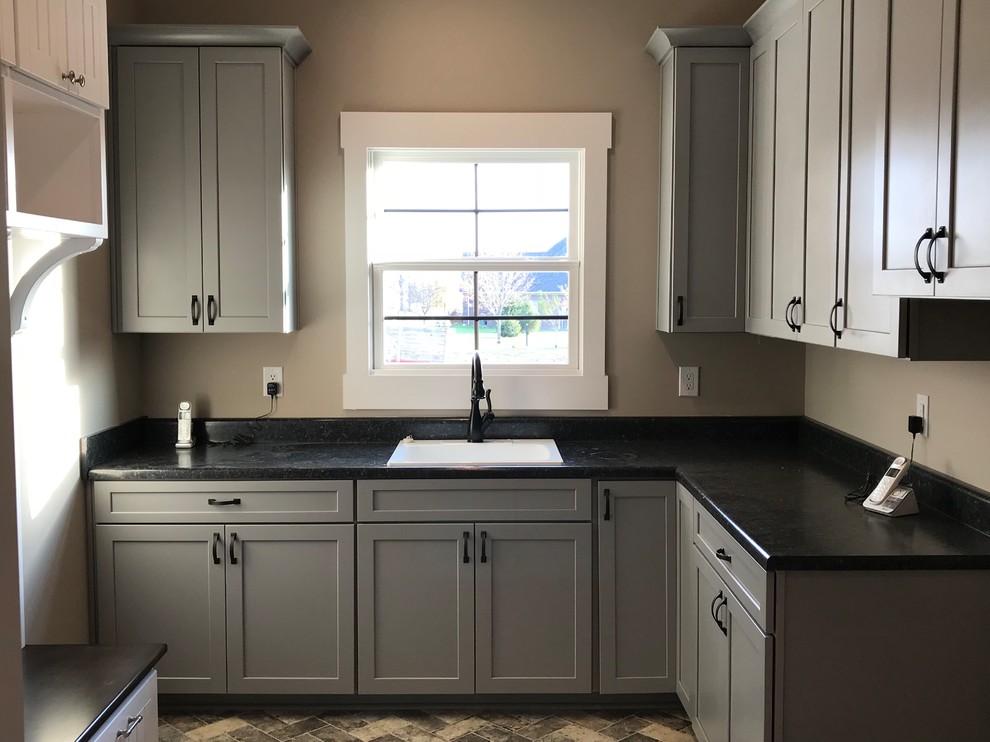 Photo of a l-shaped laundry room in Indianapolis with a drop-in sink, shaker cabinets, grey cabinets and laminate benchtops.