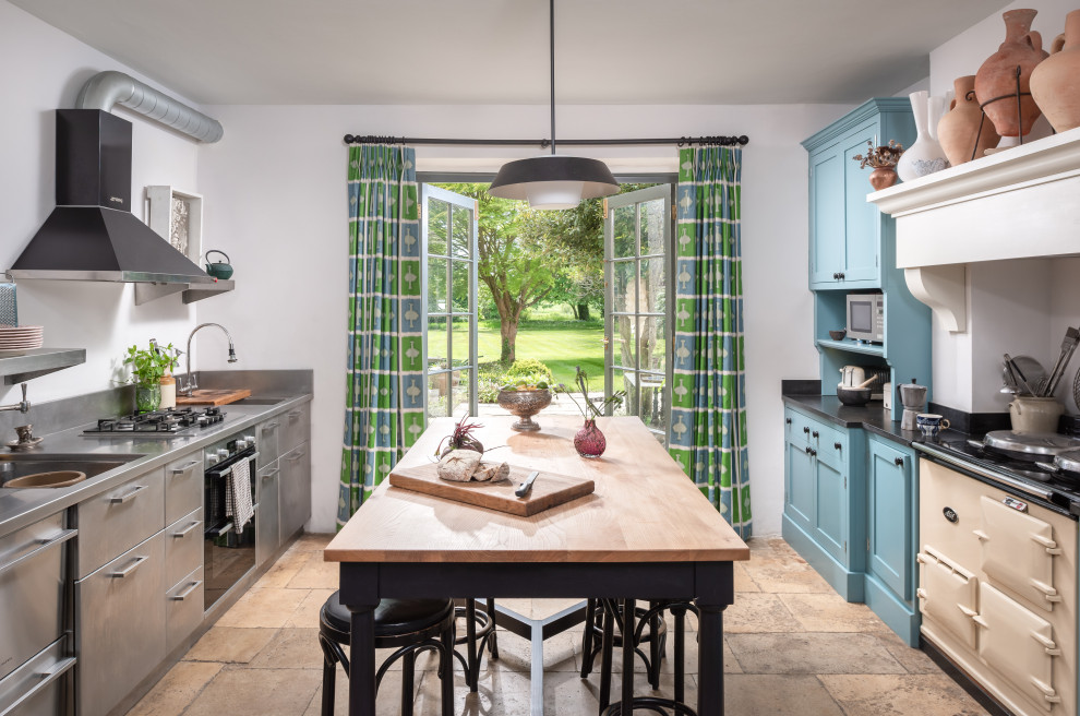 Design ideas for a medium sized traditional galley enclosed kitchen in Gloucestershire with a built-in sink, recessed-panel cabinets, blue cabinets, stainless steel worktops, coloured appliances and a breakfast bar.