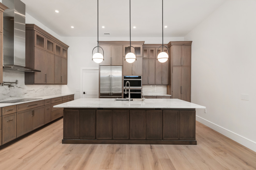 Inspiration for a large transitional galley light wood floor and brown floor eat-in kitchen remodel in Tampa with a double-bowl sink, shaker cabinets, dark wood cabinets, quartz countertops, gray backsplash, stone slab backsplash, stainless steel appliances, an island and gray countertops