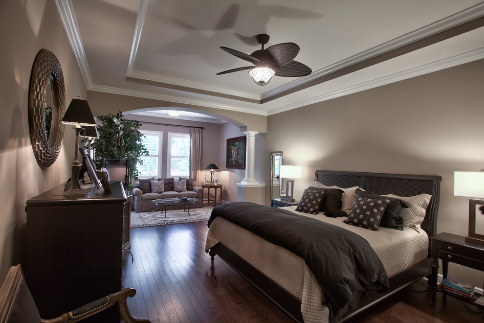 Large traditional master bedroom in Tampa with beige walls.