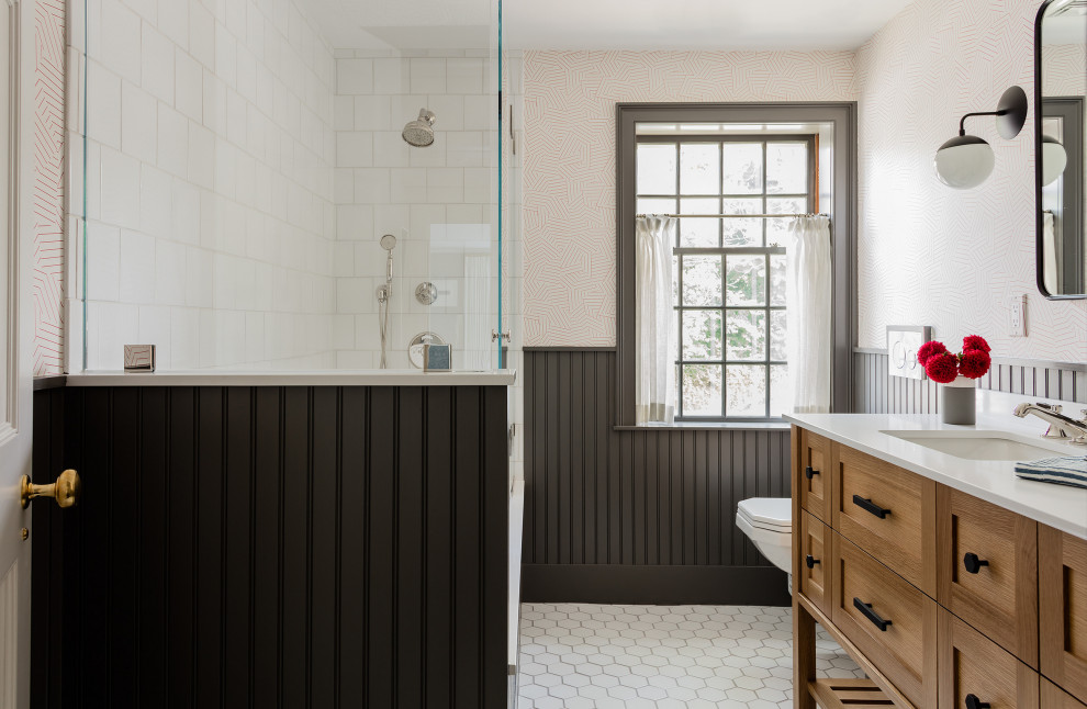 Design ideas for a mid-sized traditional kids bathroom in Boston with white tile, ceramic tile, ceramic floors, an undermount sink, marble benchtops, a hinged shower door, white benchtops, shaker cabinets, medium wood cabinets, a corner shower, beige walls, white floor, a double vanity, a freestanding vanity and decorative wall panelling.