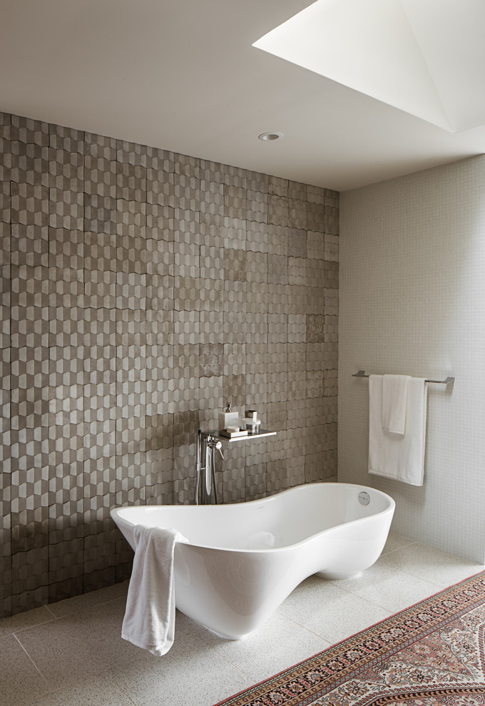 Photo of a contemporary master bathroom in Austin with a freestanding tub and gray tile.