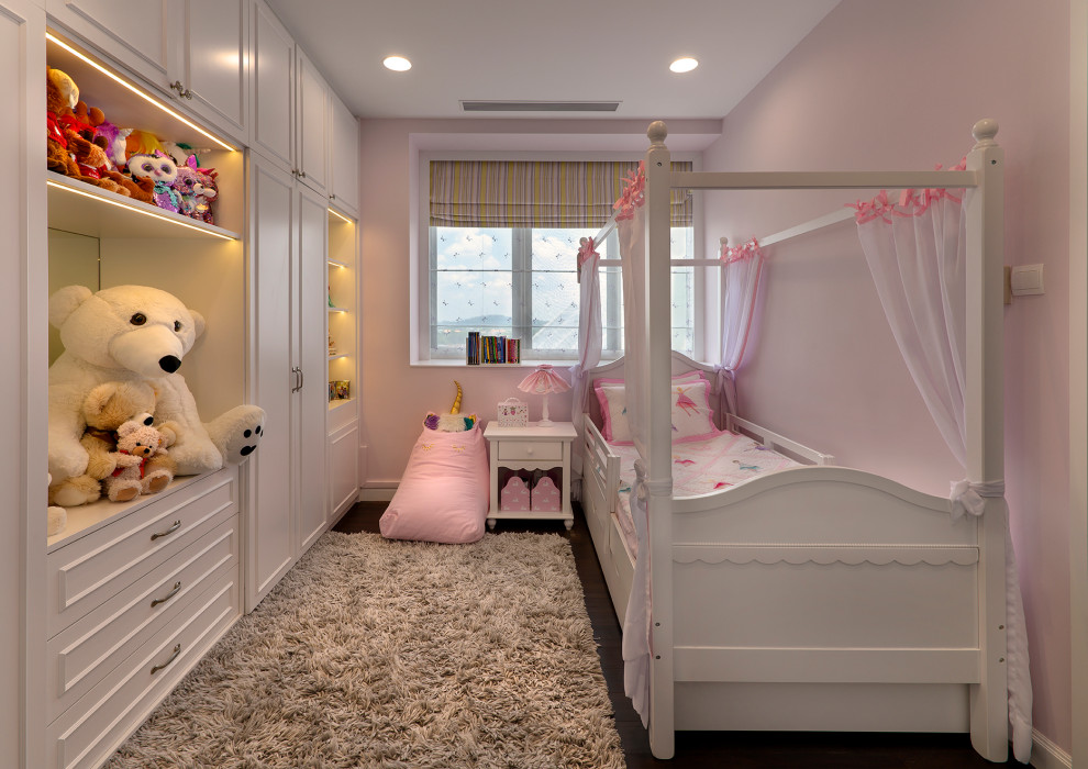 Transitional kids' room in Singapore with pink walls, dark hardwood floors and brown floor for girls.
