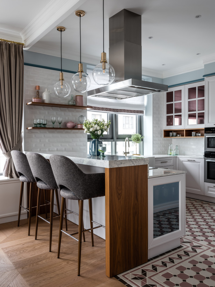 Traditional kitchen in Moscow with raised-panel cabinets, white cabinets, white splashback, metro tiled splashback, multi-coloured floors and white worktops.