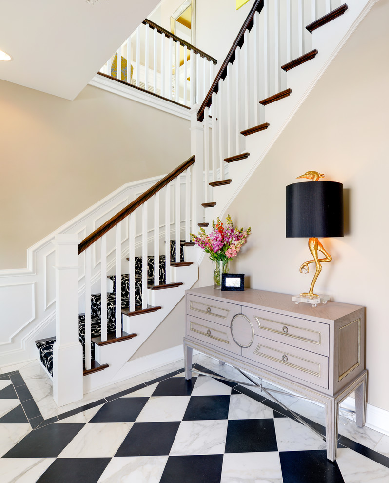 Photo of a transitional foyer in Other with beige walls.