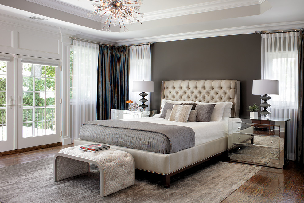 Traditional master bedroom in New York with grey walls and dark hardwood floors.
