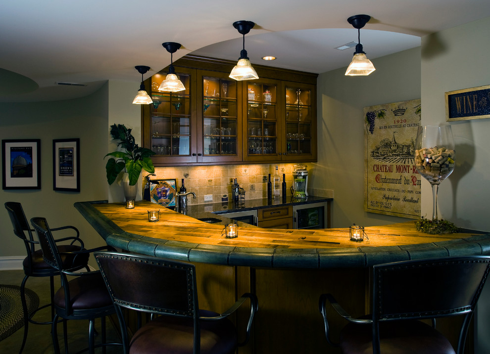Photo of a large traditional home bar in Chicago with concrete floors.