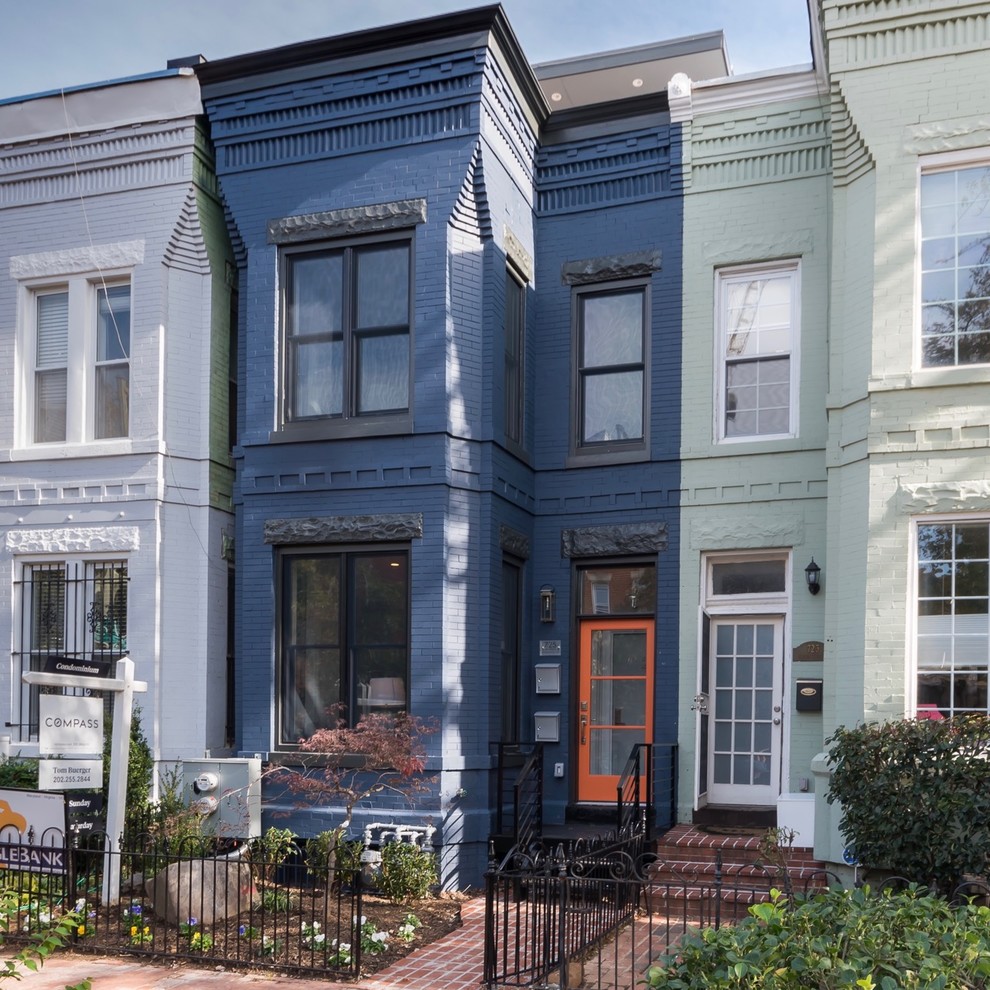 Large transitional blue three-story brick flat roof idea in DC Metro